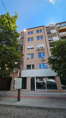 a tall building with a sign in front of it at 65 Duck House in Sofia