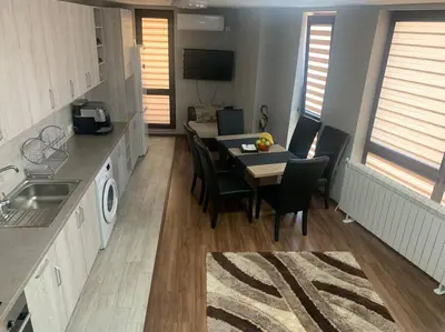 a kitchen and dining room with a table and chairs at Brown Mur in Sofia