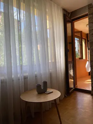 a table in front of a window with curtains at Eda Aparts in Devin