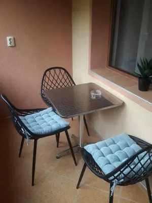 two chairs and a table and a table and chairs at Eda Aparts in Devin