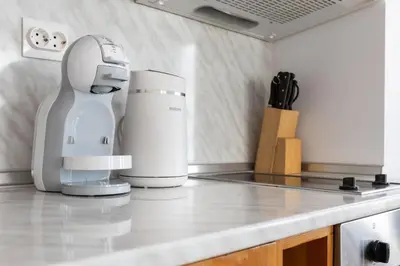 a kitchen counter with a mixer on a counter top at Light One Bed Flat next to the Ski Lift in Bansko