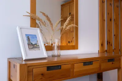 a wooden dresser with a picture on top of it at Light One Bed Flat next to the Ski Lift in Bansko