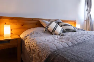 a bedroom with a bed with two pillows on it at Light One Bed Flat next to the Ski Lift in Bansko