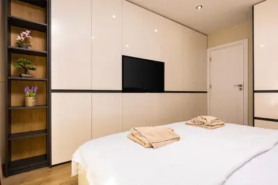 a bedroom with a bed with a flat screen tv at West Haven Apartments - 1BDs in Plovdiv Centre by Flat Mаnager in Plovdiv