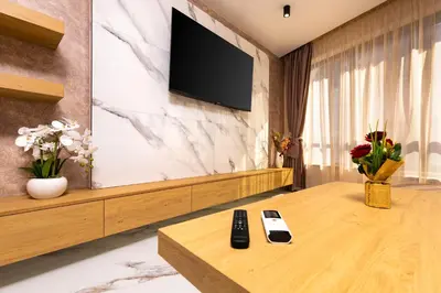 a room with a television and two remote controls on a table at West Haven Apartments - 1BDs in Plovdiv Centre by Flat Mаnager in Plovdiv