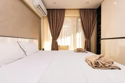 a bedroom with a white bed with towels on it at West Haven Apartments - 1BDs in Plovdiv Centre by Flat Mаnager in Plovdiv