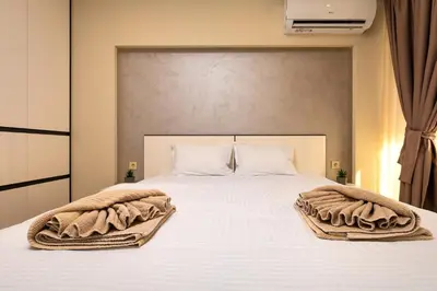 a bedroom with a white bed with towels on it at West Haven Apartments - 1BDs in Plovdiv Centre by Flat Mаnager in Plovdiv