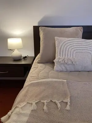 a bed with a pillow and a lamp on a table at Large One Bedroom with Terrace next to the Ski Lift in Bansko
