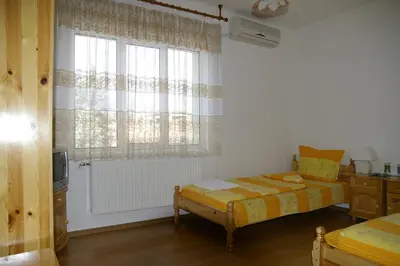 a bedroom with two beds and a window at Karadzhovy Guest House in Kalofer