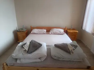 a bedroom with a bed with two pillows on it at Guest Rooms Didka in Koprivshtitsa
