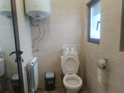 a small bathroom with a toilet and a window at Guest Rooms Didka in Koprivshtitsa