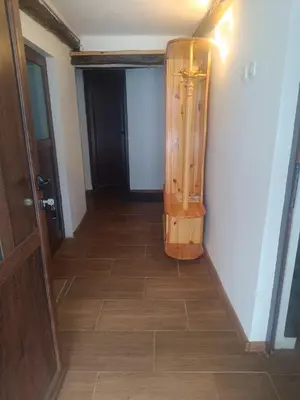 a hallway with a wooden floor and a door at Guest Rooms Didka in Koprivshtitsa