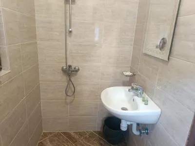 a bathroom with a sink and a shower at Guest Rooms Didka in Koprivshtitsa