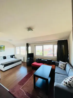 a living room with a couch and a bed at Bansko Royal Towers - Studio 856 in Bansko