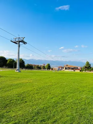 a field of green grass with a electricity pole at Bansko Royal Towers - Studio 856 in Bansko