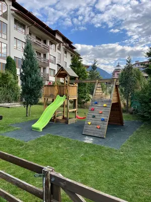 a playground with a slide in a yard at Bansko Royal Towers - Studio 856 in Bansko