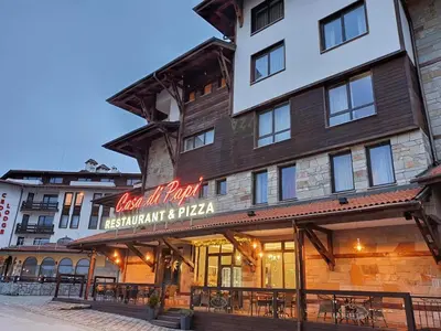 a building with a sign that reads new inn hotel restaurant and pizza at Bansko Royal Towers - Studio 856 in Bansko
