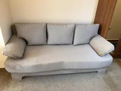 a couch with two pillows on it in a room at Simon1 studio, 2 min to gondola in Bansko