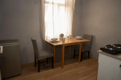 a table and chairs in a kitchen with a window at The Cozy Corner in Sofia