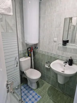 a bathroom with a toilet and a sink at Monfort В in Bansko