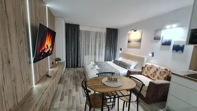 a living room with a couch and a table at Monfort В in Bansko