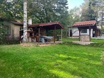 a house with a gazebo in a yard at Villa Yarema Mountain Relax with Hot Jacuzzi & Sauna by BookVillaBG in Zheleznitsa
