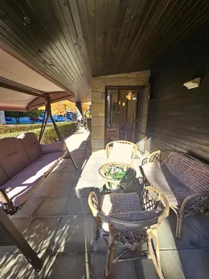 a patio with a couch and a table and chairs at Apartment ZAX B7 in Terra Complex in Bansko