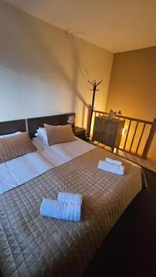 a bedroom with a large bed with two pillows on it at Apartment ZAX B7 in Terra Complex in Bansko