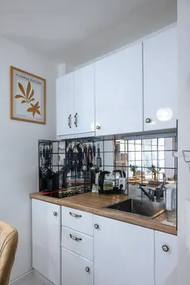 a kitchen with white cabinets and a sink at Cozy Studio - Your Home Away From Home by Flat Mаnager in Sofia