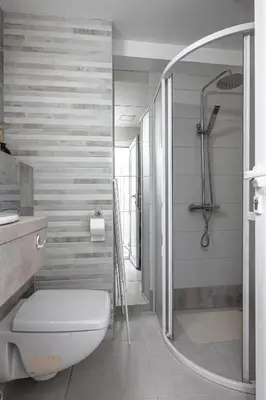 a bathroom with a white toilet and a shower at Cozy Studio - Your Home Away From Home by Flat Mаnager in Sofia