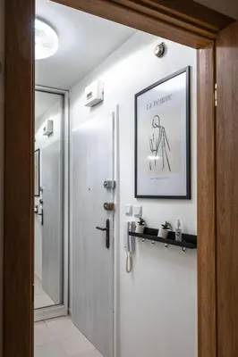 a bathroom door with a picture of a man on the wall at Cozy Studio - Your Home Away From Home by Flat Mаnager in Sofia