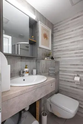 a bathroom with a sink and a toilet and a mirror at Cozy Studio - Your Home Away From Home by Flat Mаnager in Sofia