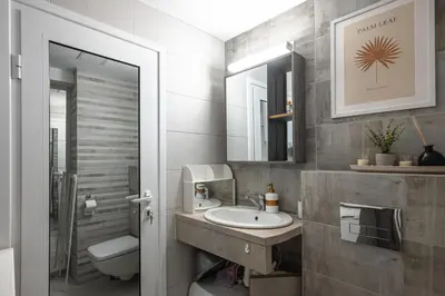 a bathroom with a sink and a toilet and a mirror at Cozy Studio - Your Home Away From Home by Flat Mаnager in Sofia