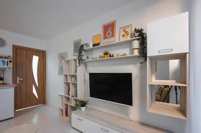 a living room with a flat screen tv on a wall at Cozy Studio - Your Home Away From Home by Flat Mаnager in Sofia