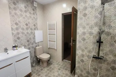 a bathroom with a toilet and a shower and a sink at Budget overnight- Struma highway in Pernik