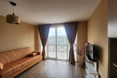 a living room with a couch and a large window at Budget overnight- Struma highway in Pernik