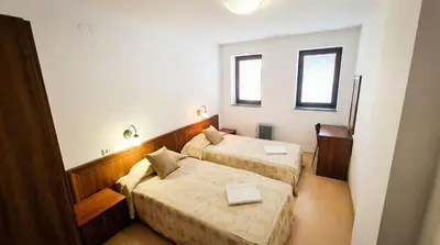 a hotel room with two beds and two windows at Mountain Paradise 4 - 1 Bedroom - Gondola, 100m away - Washer in Bansko