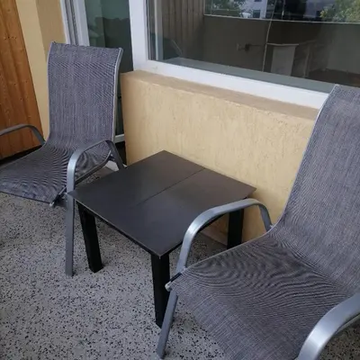 two chairs and a table in front of a window at M Art Apart in Sofia