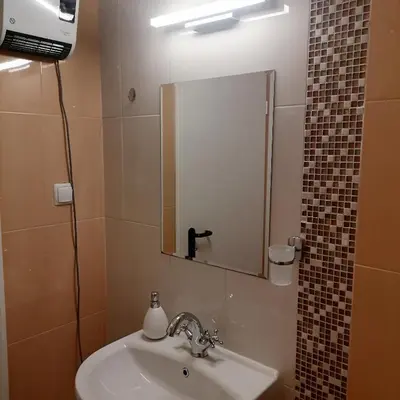 a bathroom with a sink and a mirror at M Art Apart in Sofia