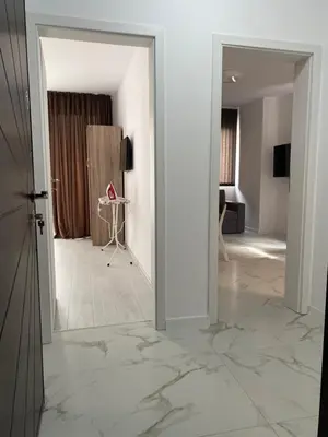 an open door into a living room with a hallway at Апартамент Узунови in Sandanski