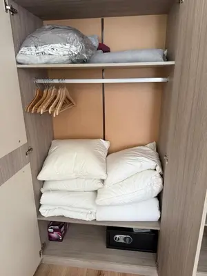 a closet with white pillows in it with at Nova #7 in Sofia