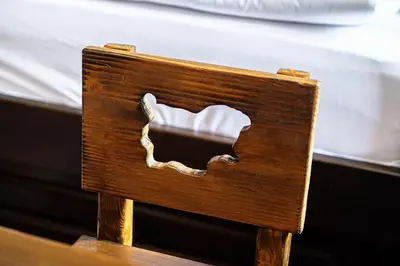 a wooden chair with a hole in the back of it at Къща ЕТНО in Koprivshtitsa