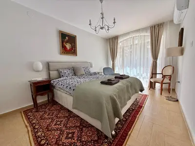 a bedroom with a bed and a chandelier at Next to the Ski Lift Downtown Bansko in Bansko