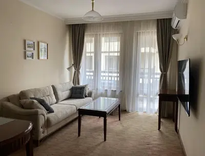 a living room with a couch and a coffee table at Next to the Ski Lift Downtown Bansko in Bansko