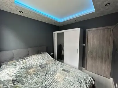 a bedroom with a bed with a blue ceiling at Paradise M Apartments in Plovdiv