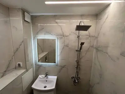 a bathroom with a sink and a toilet and a mirror at Paradise M Apartments in Plovdiv