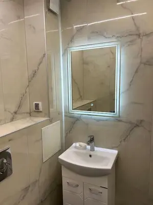a white bathroom with a sink and a mirror at Paradise M Apartments in Plovdiv