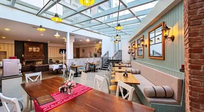 a restaurant with tables and chairs in a room at 2 bed 2 bath, 4 min walk to slope, Predela2, Bansko in Bansko