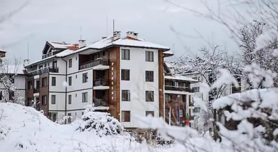 a building covered in snow with snow covered trees at 2 bed 2 bath, 4 min walk to slope, Predela2, Bansko in Bansko