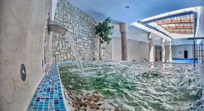a large swimming pool with a water fountain at 2 bed 2 bath, 4 min walk to slope, Predela2, Bansko in Bansko